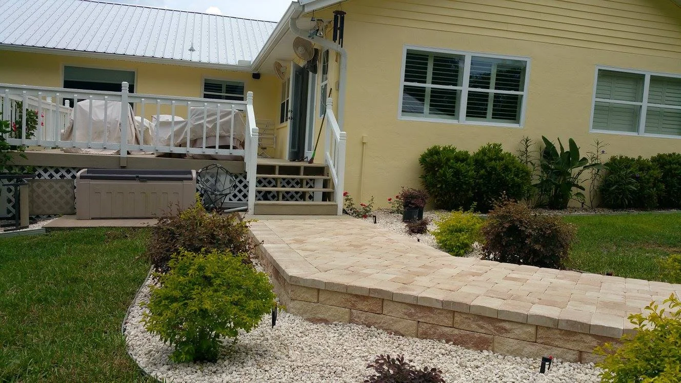 Paved pathway leading to a house.