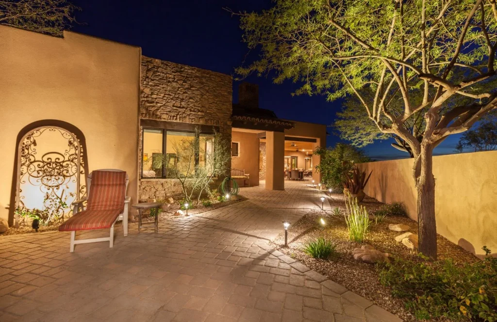Landscape lighting along a residential courtyard and garden wall at night